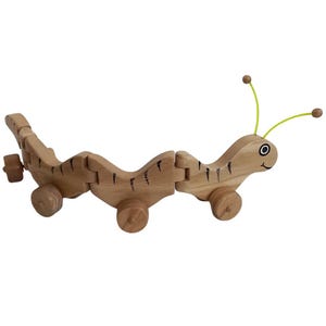 children&#39;s toy, moving caterpillar on wheels, handmade, made of wood, covered with ecological varnish, moves in two directions