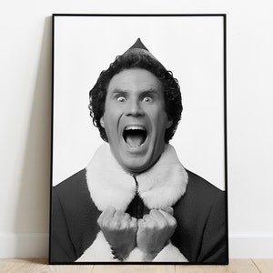May include: Black and white photo of a man wearing a Santa hat and a white fur collar, with his mouth open in a wide smile and his fists clenched.