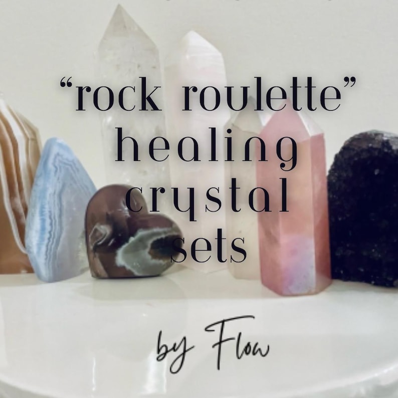 May include: A collection of various healing crystals, including clear quartz, pink quartz, and agate, arranged on a white surface. The text "rock roulette healing crystal sets by Flow" is displayed in the image.
