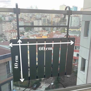 May include: Black metal balcony table with slatted wood top. The table measures 40 cm by 60 cm.