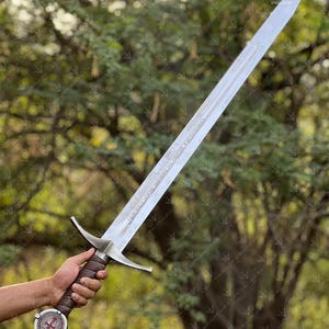 The Accolade Sword of the Knights Templar is a magnificent weapon of ceremony and devotion — a blade worthy of a Grand Master himself. Named “The Accolade,” this sword symbolizes the moment of knighthood, where a loyal member of the Order would be dubbed in service of faith. Its Latin inscription, “Non Nobis, Domine, Non Nobis, Sed Nomini Tuo Da Gloriam” defines the creed and humility of the Templars who shaped medieval history through faith and steel.