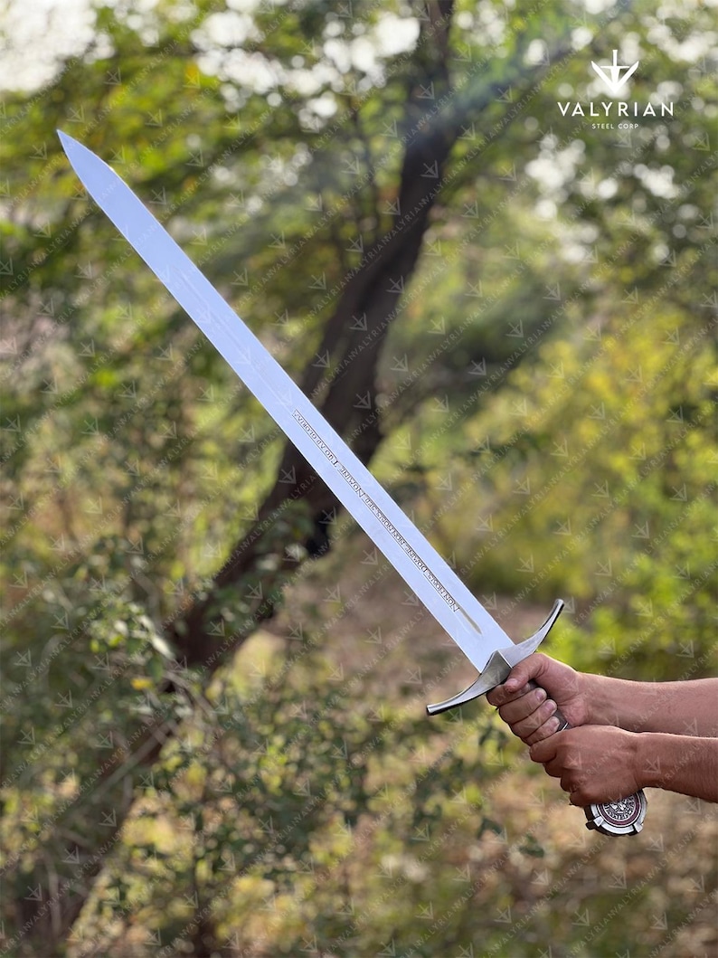 The Accolade Sword of the Knights Templar is a magnificent weapon of ceremony and devotion — a blade worthy of a Grand Master himself. Named “The Accolade,” this sword symbolizes the moment of knighthood, where a loyal member of the Order would be dubbed in service of faith. Its Latin inscription, “Non Nobis, Domine, Non Nobis, Sed Nomini Tuo Da Gloriam” defines the creed and humility of the Templars who shaped medieval history through faith and steel.
