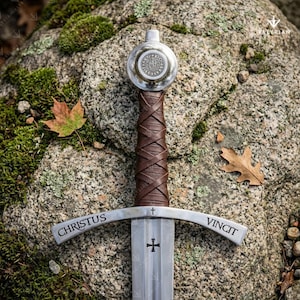 Faithkeeper Sword of the Knights Templar replica featuring a high carbon steel blade, leather grip, and engraved crossguard with scabbard.