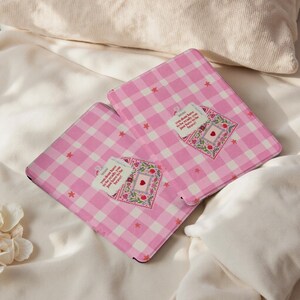 May include: Two pink and white gingham notebooks. Each notebook features a decorative patch with a heart and the text "you don't have to be ready, you just have to be brave!"