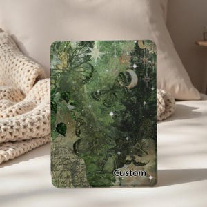 May include: A custom tablet case featuring a green and gold design with butterflies, stars, and a crescent moon. The case has the word "Custom" printed on the bottom right corner.