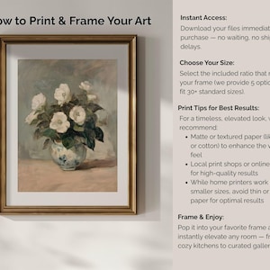 May include: A framed art print featuring a still life of white flowers in a decorative vase. The artwork is in a gold frame and includes text about printing and framing art, with tips for best results.