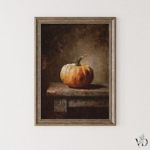 May include: A framed still life painting of a pumpkin. The pumpkin is orange and sits on a weathered wooden table. The background is a dark, blurred mix of browns and greens, creating a classic, rustic aesthetic.