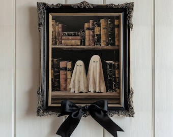 May include: A framed painting featuring two ghost figures in front of a bookshelf filled with old books. The painting is in a black ornate frame with a black satin bow attached below. The artwork has a vintage, Halloween theme.