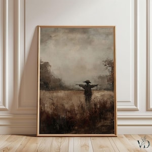 Könnte beinhalten: Ein gerahmtes Kunstwerk zeigt eine Vogelscheuche auf einem Feld unter einem bewölkten Himmel. Das Gemälde verwendet eine gedämpfte Farbpalette aus Braun-, Beige- und Grautönen und erzeugt eine rustikale und Vintage-Ästhetik. Das Kunstwerk wird auf einem Holzboden ausgestellt.