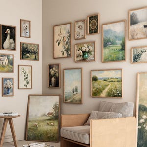 May include: A collection of framed landscape and floral art prints in various sizes and styles. The artwork features pastoral scenes, botanical illustrations, and a goose portrait, all in wooden frames, creating a gallery wall aesthetic.