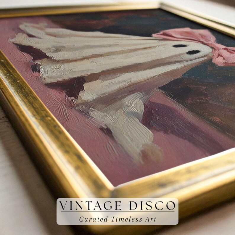 May include: An oil painting in a gold frame depicts a whimsical ghost with a pink bow. The ghost is draped in white fabric with two black eyes. The background is a mix of dark and light colors, with the text "VINTAGE DISCO" at the bottom.