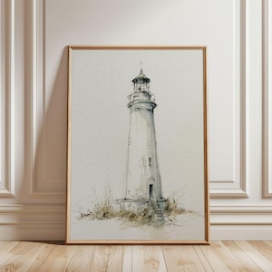 May include: A framed watercolor illustration of a tall, slender lighthouse standing on a grassy dune. The artwork features muted gray and brown ink lines on a textured off-white paper, capturing the structure's lantern room and base.