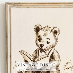 May include: A framed sepia-toned print featuring a charming bear reading a book. The bear is wearing a bow tie and suspenders. The print has the text "VINTAGE DISCO" and "Curated Timeless Art" at the bottom.