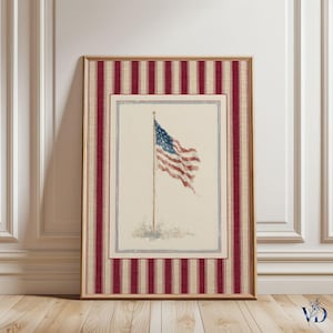 May include: Framed print of the American flag waving on a pole. The artwork features a watercolor style with red, white, and blue hues. The frame has a red and cream striped pattern, adding a vintage touch to the patriotic theme.