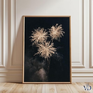 May include: A framed art print featuring a dark background with three golden fireworks bursts. The fireworks are detailed with radiating lines, creating a bright contrast against the black backdrop. The print is in a wooden frame.
