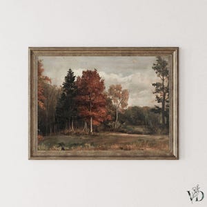 Op de afbeelding: Een ingelijst landschapsschilderij in antieke stijl. Het kunstwerk toont een boslandschap met bomen in tinten rood, bruin en groen, onder een bewolkte hemel. Het schilderij zit in een houten lijst, wat bijdraagt aan de vintage uitstraling.