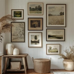 May include: A gallery wall featuring framed landscape art in various sizes and styles. The artwork includes depictions of fields, trees, and serene natural scenes. Decorative vases and a woven basket add to the room's rustic aesthetic.