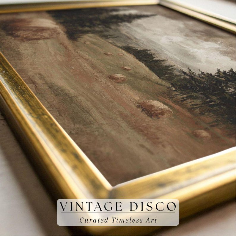 May include: A framed landscape painting with a gold-colored frame. The artwork depicts a hillside with a muted color palette of browns, greens, and grays. The text "VINTAGE DISCO" and "Curated Timeless Art" is displayed at the bottom.