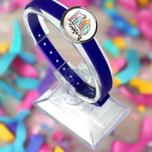 May include: A blue silicone bracelet with a silver charm that says "My Faith Can Move Mountains".