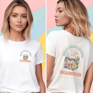 May include: White t-shirt with a graphic print of a dome-shaped building with flowers and the text "Self-Proclaimed Imagineer" on the front and back.