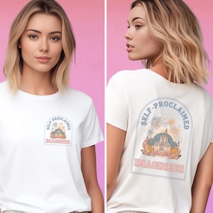 May include: White t-shirt with a graphic of a castle and fireworks with the text "Self-Proclaimed Imagineer" on the back. The front of the shirt has a smaller version of the graphic.