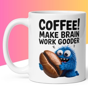 May include: White ceramic coffee mug with the text "COFFEE! MAKE BRAIN WORK GOODER" in black. A cartoon blue monster with a coffee bean is on the front. The mug has a white handle.