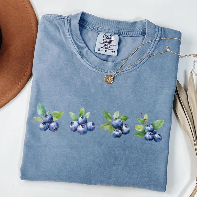 This image consists of Blueberry design for blue jean shirt.