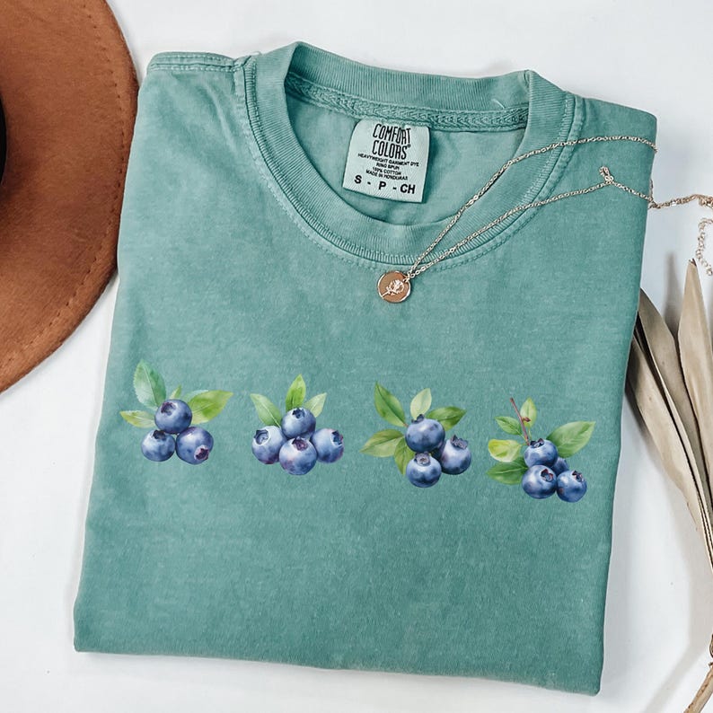 This image consists of Blueberry design for light green shirt.