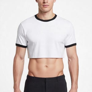 May include: White crop top with black trim on the collar and sleeves. The shirt is a short-sleeved, crew neck style. The model is wearing black pants.