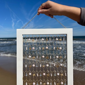 Pink Pearl Suncatcher: Handmade using wooden frame, gold chicken wire, shimmery pink & iridescent glass beads, and gold starfish charms.