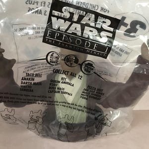 May include: A sealed plastic bag featuring Star Wars Episode I: The Phantom Menace branding. The bag contains a collectible toy from Taco Bell, KFC, and Pizza Hut. The bag lists characters like Anakin, Darth Maul, and Yoda.