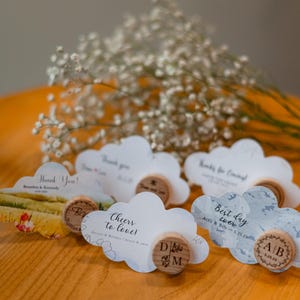 Garden baby shower favors in bulk, custom engraved wine bottle stoppers, cloud thank you cards, classic wedding accessories