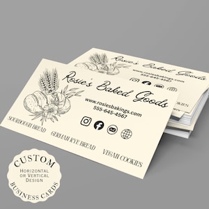 May include: A stack of cream-coloured business cards with the text "Rosie's Baked Goods" and contact details. The cards feature illustrations of bread and wheat. A circular design at the bottom says "Custom Business Cards".