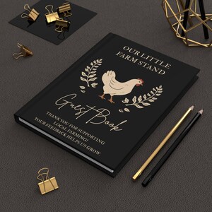 May include: A black guest book featuring a cream-colored chicken illustration, leafy branches, and the text Our Little Farm Stand Guest Book. Below the text, it reads Thank you for supporting local farming! Your feedback helps us grow.