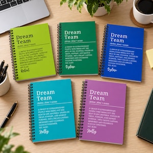 May include: Five spiral-bound notebooks in lime green, dark green, blue, teal, and purple. Each cover features the white text Dream Team, a dictionary-style definition, and a personalized name: Robert, Dylan, or Holly, printed in white.