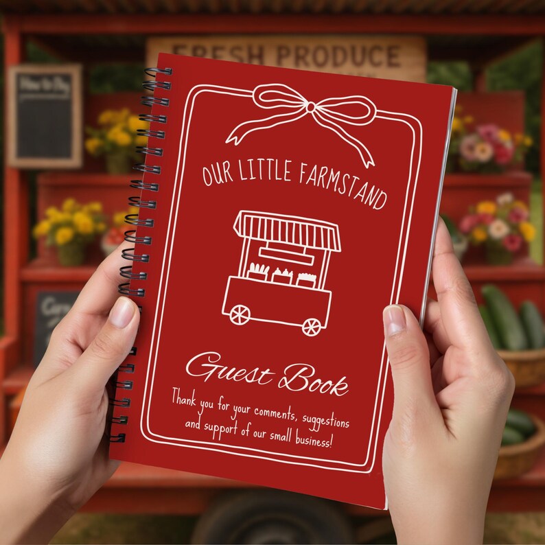 May include: A red spiral-bound guest book with white text and illustrations. The cover reads "Our Little Farmstand Guest Book" with a drawing of a farm stand. The text also includes a thank you message for comments and support.