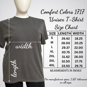 May include: A gray Comfort Colors 1717 unisex t-shirt displayed on a mannequin. The image includes a size chart with measurements in inches for sizes S through 4XL. The chart shows the length and width of the shirts.
