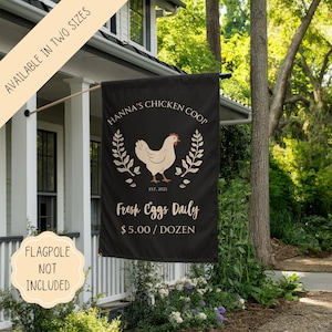 May include: Black and white garden flag with a white chicken illustration and the text "Hanna's Chicken Coop Est. 2025 Fresh Eggs Daily $5.00/Dozen".