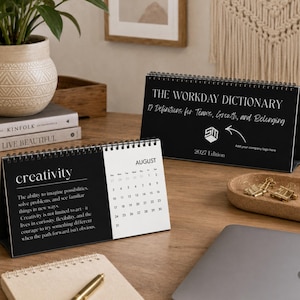 May include: A black and white desk calendar titled The Workday Dictionary 12 Definitions for Teams, Growth, and Belonging 2027 Edition. The open page displays the word creativity with a definition and the month of August with a grid of dates.