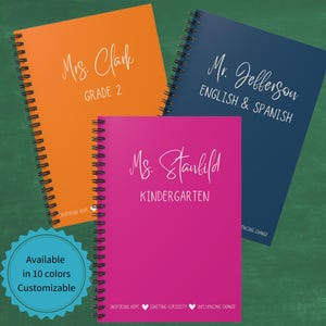 May include: Three spiral bound notebooks with different colored covers. The orange notebook says "Mrs. Clark, Grade 2". The blue notebook says "Mr. Jefferson, English & Spanish". The pink notebook says "Ms. Stanfield, Kindergarten".