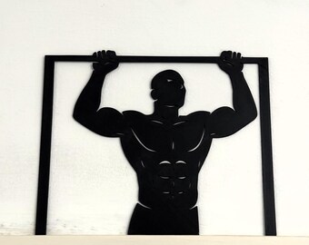 Puede incluir: Silueta negra de una persona musculosa haciendo dominadas, enmarcada en un rectángulo negro. La figura destaca su físico definido, con abdominales visibles y hombros anchos. La obra de arte se encuentra sobre un fondo blanco, creando un fuerte contraste.