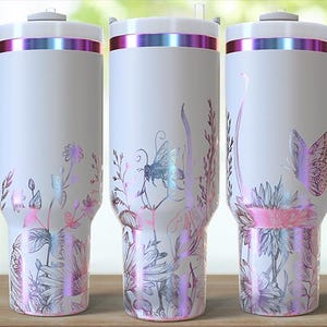 May include: White travel mug with a handle, featuring a floral and insect design in pink, purple, and silver. The mug has a silver rim with a pink and purple iridescent band. The bottom of the mug has a floral design. The mug has the words "Uniquely Sami" on it.