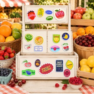 May include: A wooden display stand filled with colorful fruit stickers, including strawberries, pears, and lemons. Baskets of fresh fruit, such as oranges, apples, and cherries, surround the stand, creating a vibrant market scene.