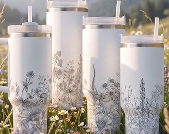 May include: Four white stainless steel tumblers of varying heights, each featuring a delicate dark gray botanical line art illustration of wildflowers. Every tumbler includes a clear lid and a matching white straw for drinking beverages.