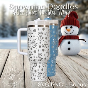 May include: Two 40oz laser-wrapped tumblers with winter-themed designs. One tumbler is white with a black snowman and snowflake pattern, the other is light blue with a silver snowman design. A snowman figure with a red hat and scarf is also present.