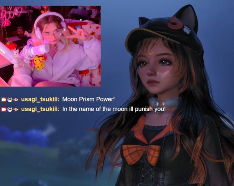 May include: A digital avatar with long dark hair wearing a black cat-ear cap, a crescent moon forehead mark, and a black outfit with an orange plaid bow. A small inset video shows a person wearing headphones and a white zip-up hoodie with chat text.