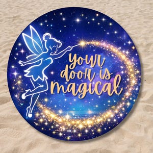 May include: Round blue decorative item with a fairy illustration and the text "your door is magical". The fairy is outlined in white, with a wand creating a sparkling trail. The background is a starry night sky.