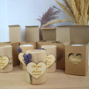May include: Wooden candle holders with a heart-shaped wooden tag that says "Giorgia & Luciano 05.09.2024". The candle holders are decorated with dried lavender.