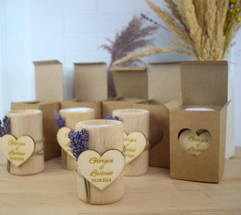 May include: Wooden candle holders with a heart-shaped wooden tag that says "Giorgia & Luciano 05.09.2024". The candle holders are decorated with dried lavender.