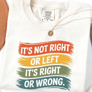 May include: Ivory t-shirt with a retro-style graphic that reads "It's not right or left, it's right or wrong."